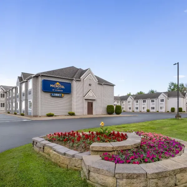 Microtel Inn by Wyndham Albany Airport exterior with landscaped grounds